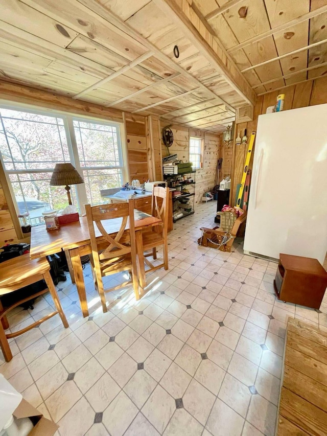 dining room with wood walls and wood ceiling