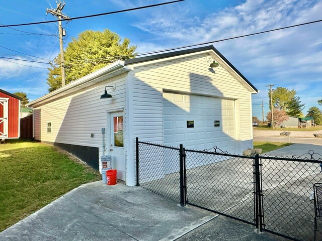 view of side of property with an outbuilding and a lawn