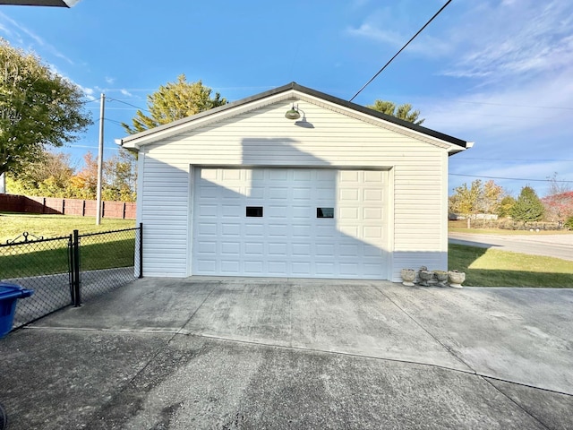 detached garage featuring fence