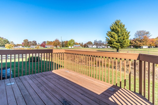 wooden terrace featuring a yard