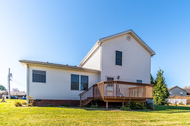 rear view of house featuring a deck and a lawn