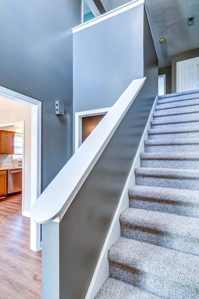 stairs featuring hardwood / wood-style floors