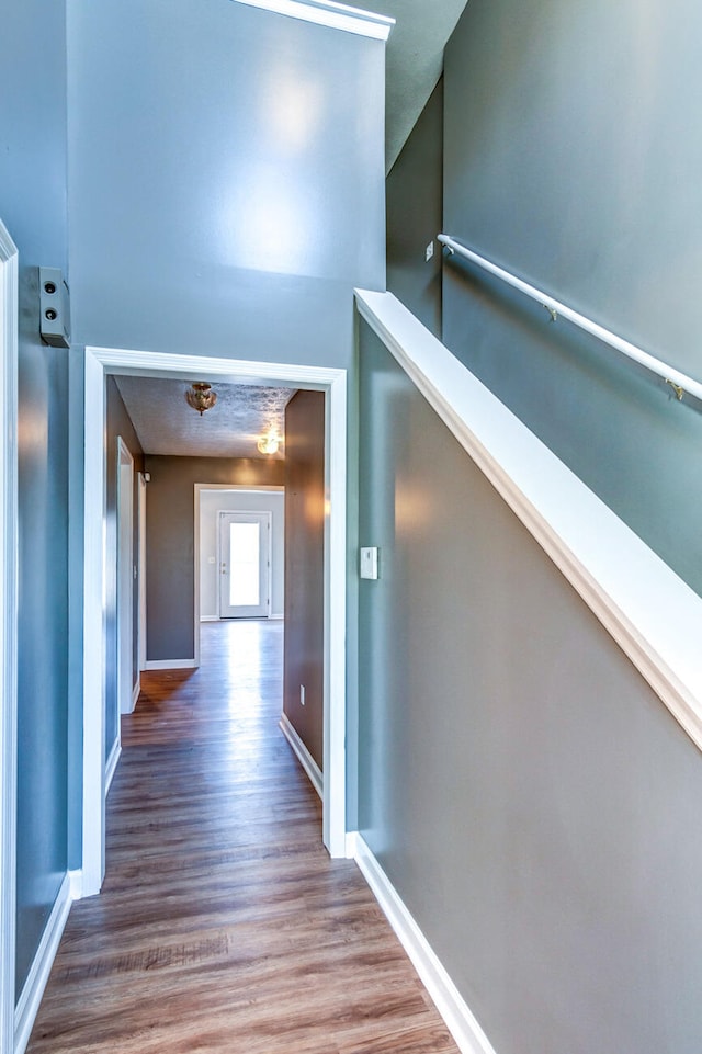 corridor with hardwood / wood-style flooring