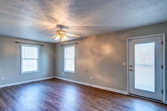 unfurnished room featuring a textured ceiling, dark wood-type flooring, and ceiling fan