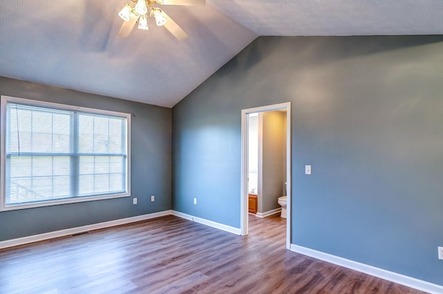 unfurnished room featuring lofted ceiling, wood-type flooring, and ceiling fan