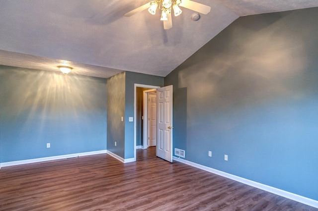 spare room featuring lofted ceiling, a textured ceiling, dark hardwood / wood-style floors, and ceiling fan