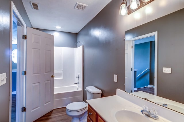 full bathroom with toilet, hardwood / wood-style floors, vanity, and shower / bath combination