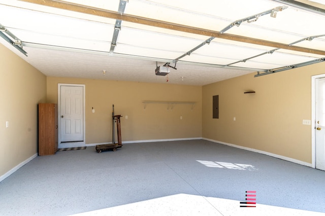 garage with a garage door opener and electric panel