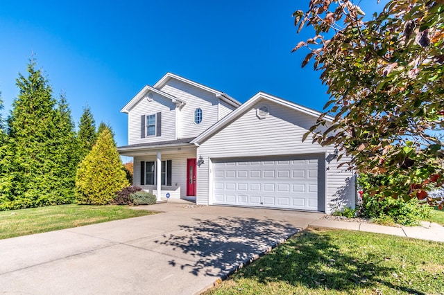 view of property with a front yard and a garage