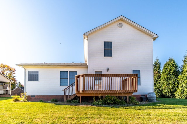 rear view of property with a wooden deck and a yard