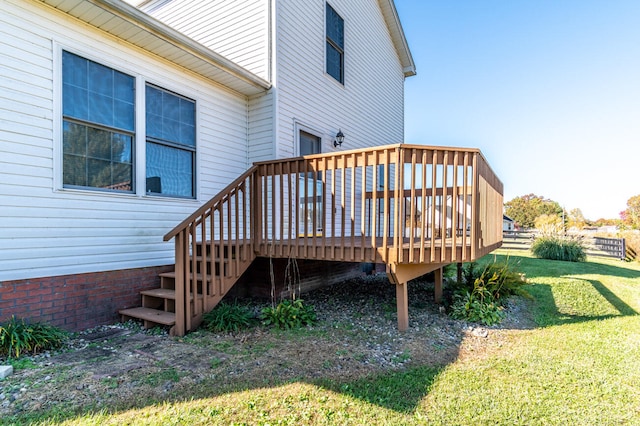 wooden deck featuring a lawn