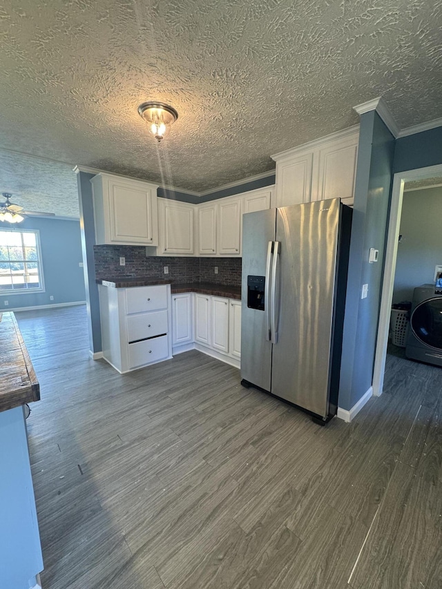 kitchen featuring washer / clothes dryer, stainless steel fridge with ice dispenser, a textured ceiling, white cabinetry, and dark hardwood / wood-style floors