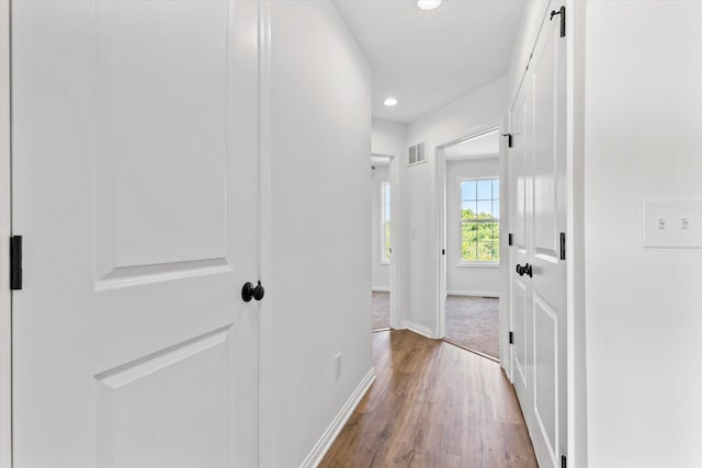 hallway with wood-type flooring