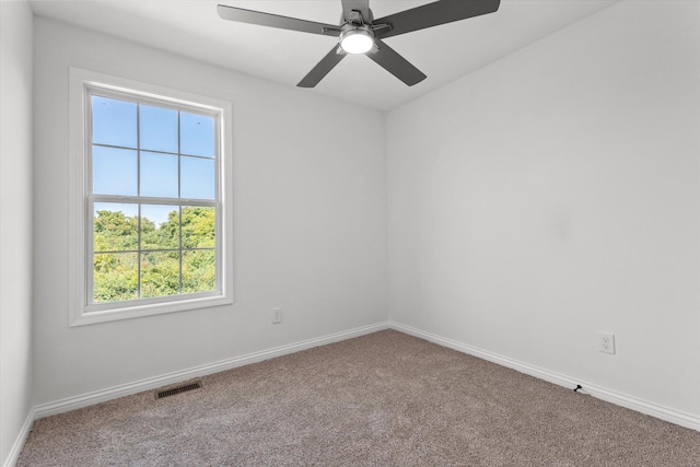 empty room featuring carpet flooring, a healthy amount of sunlight, and ceiling fan