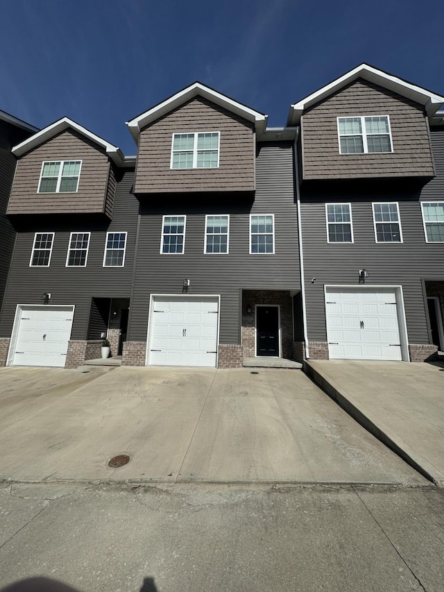 rear view of property featuring a garage