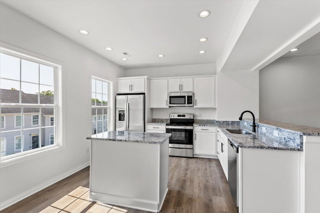 kitchen featuring white cabinetry, light hardwood / wood-style floors, stainless steel appliances, and sink