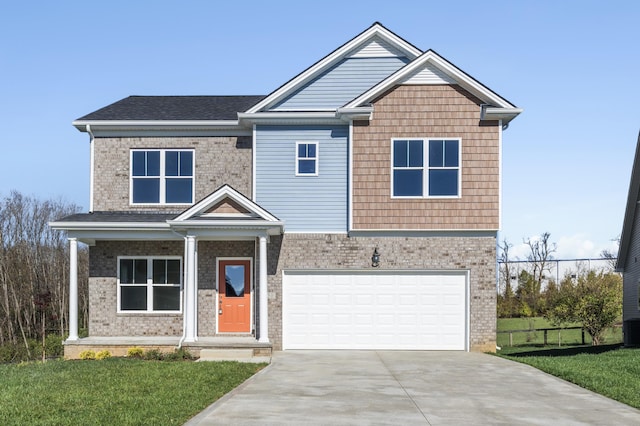 craftsman inspired home with a front yard and a garage