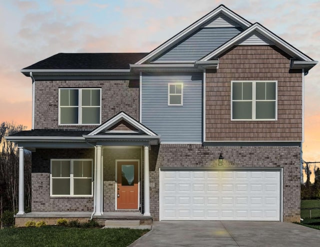 view of front facade featuring a garage, concrete driveway, and brick siding