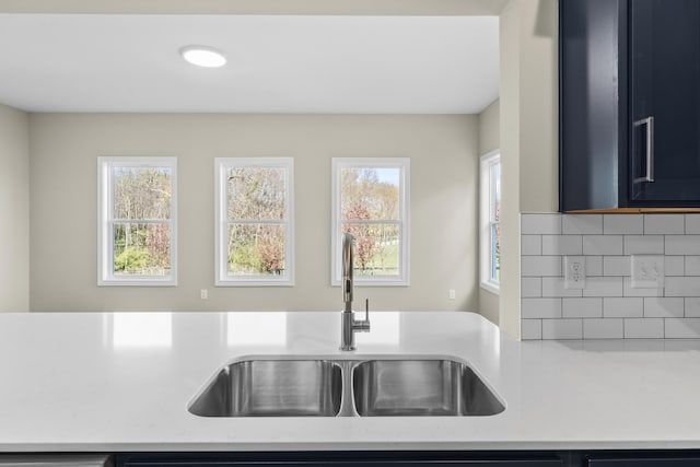 kitchen with tasteful backsplash and a sink