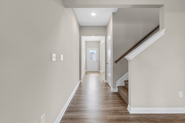 corridor with hardwood / wood-style floors