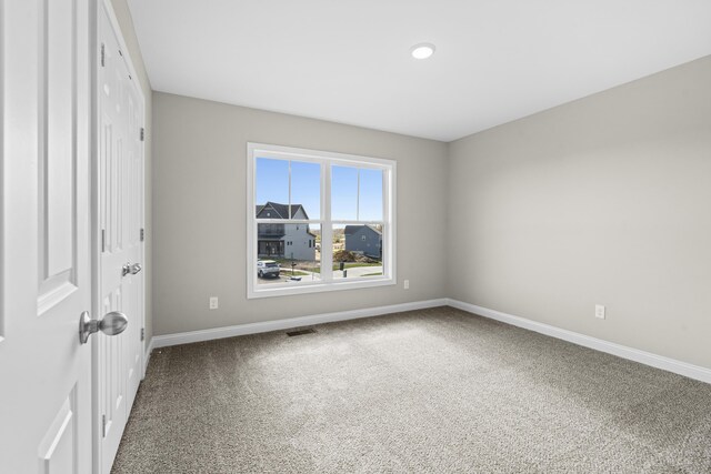 unfurnished bedroom with dark colored carpet and a closet