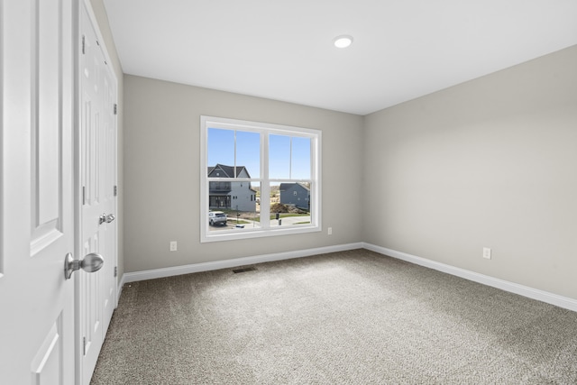 unfurnished bedroom featuring carpet, visible vents, and baseboards