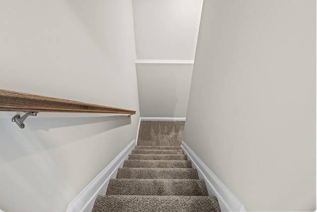 staircase with carpet floors and baseboards