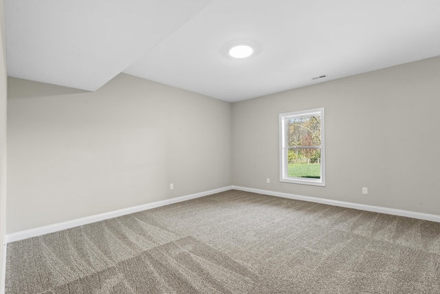 empty room featuring carpet flooring and baseboards