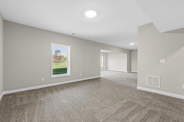 carpeted empty room with visible vents and baseboards