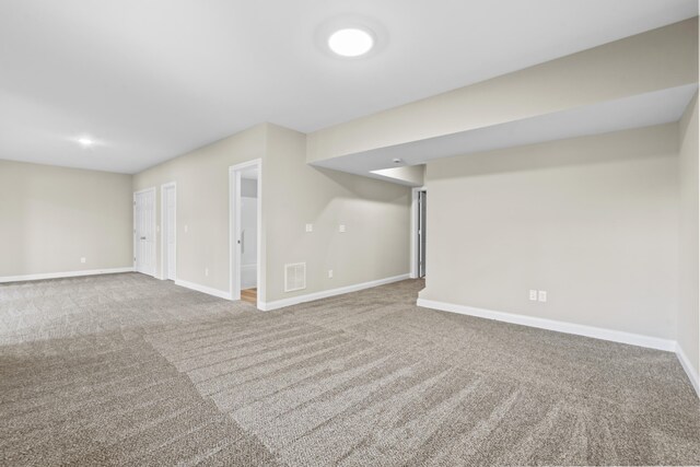 basement featuring carpet and a healthy amount of sunlight