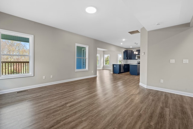 unfurnished living room with dark hardwood / wood-style floors