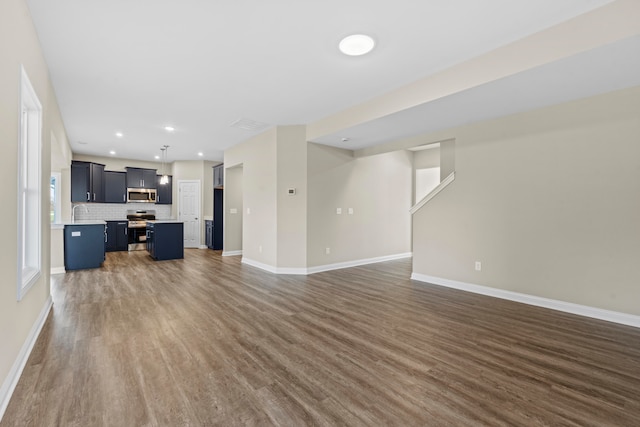 unfurnished living room with dark hardwood / wood-style flooring