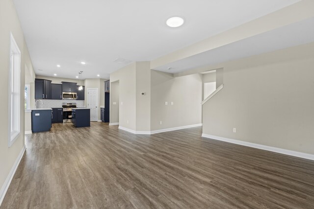 unfurnished room with dark hardwood / wood-style flooring