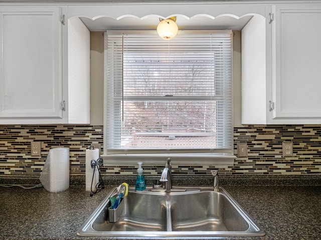 kitchen featuring white cabinets, dishwasher, light wood-type flooring, and a wealth of natural light