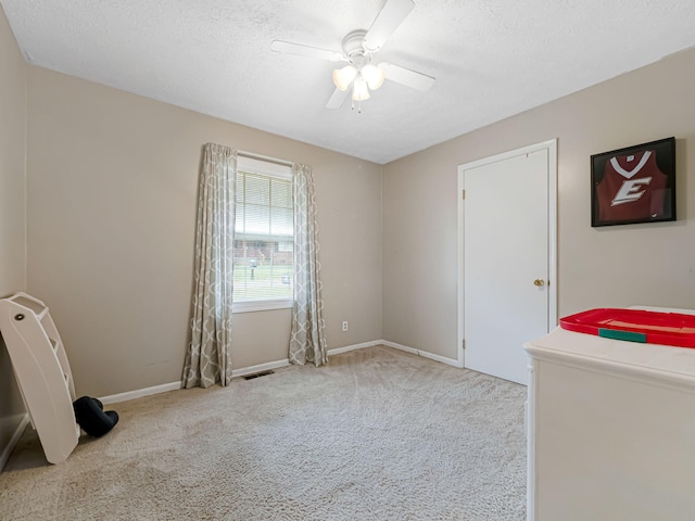 bathroom featuring tile patterned flooring, a textured ceiling, toilet, vanity, and tile walls