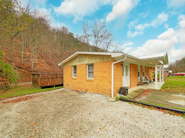 ranch-style house featuring covered porch and a front lawn