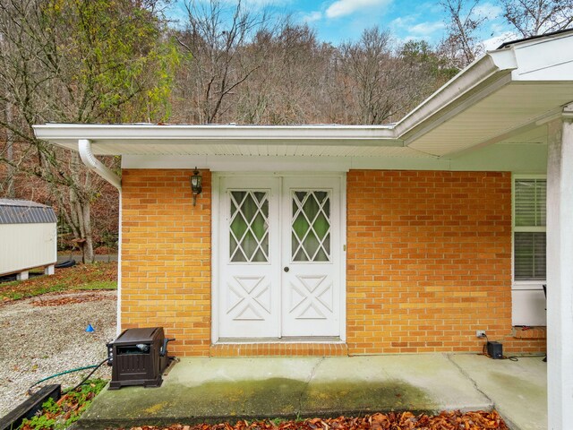 view of property exterior featuring a deck and a patio