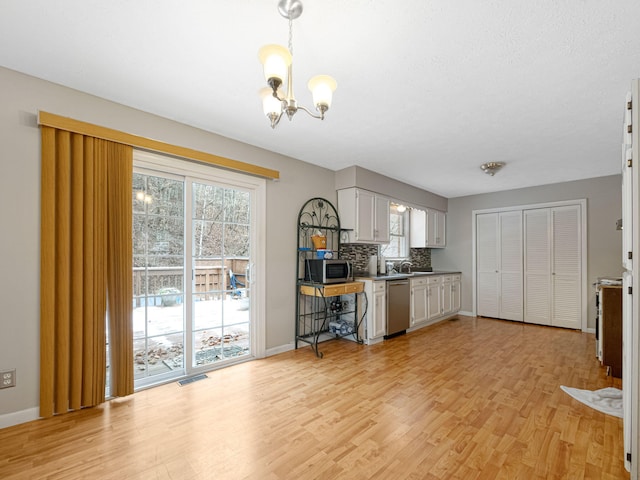 hallway with light carpet and a textured ceiling