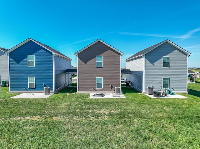 rear view of house featuring a yard, a patio area, and central AC