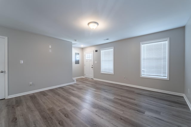 spare room featuring hardwood / wood-style flooring and electric panel