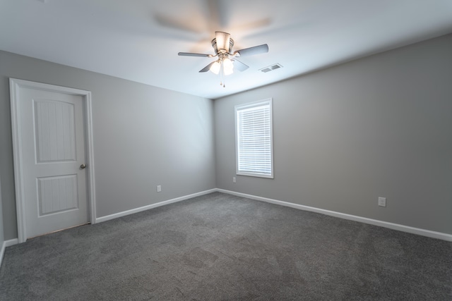 carpeted spare room with ceiling fan