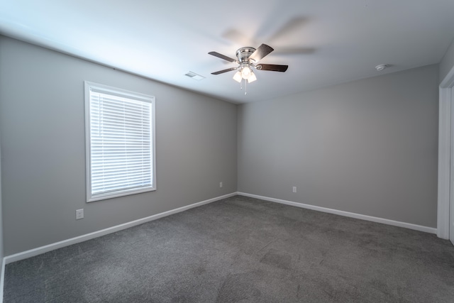 carpeted spare room with ceiling fan