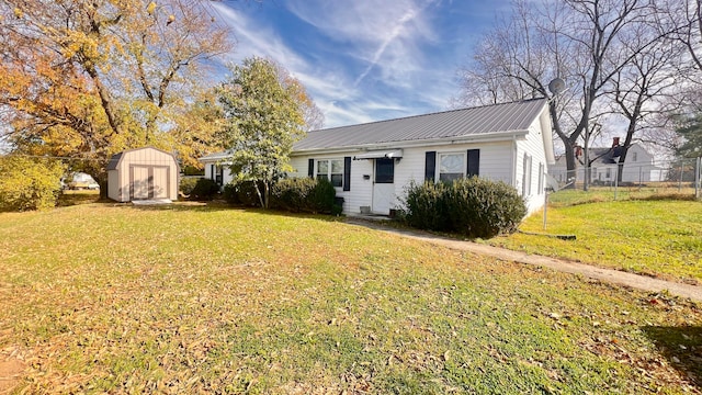 view of front of property with a storage shed and a front yard