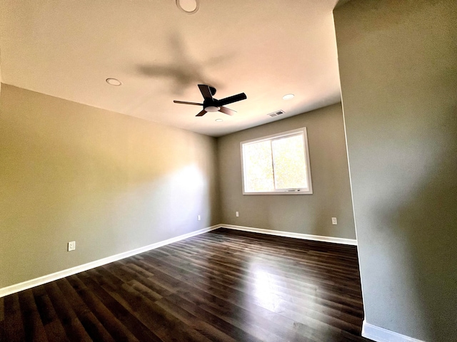 spare room featuring dark hardwood / wood-style floors and ceiling fan