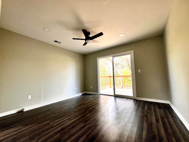 unfurnished room with ceiling fan and dark hardwood / wood-style floors