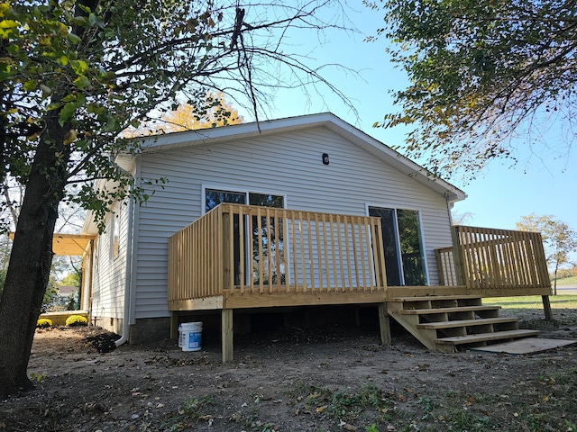 back of house featuring a deck