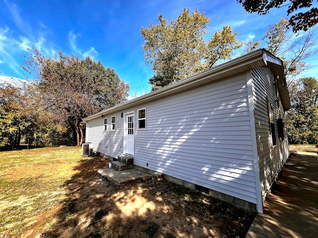 view of home's exterior with a yard and cooling unit