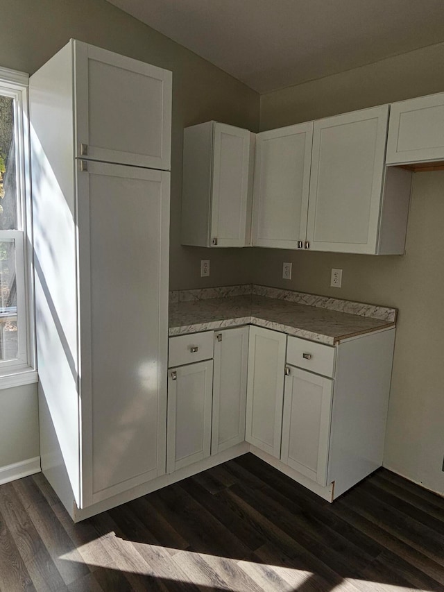 kitchen with white cabinets and dark wood-type flooring