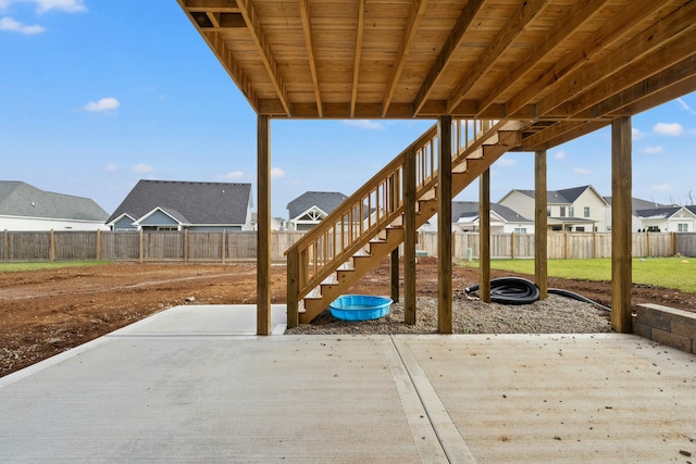 view of patio / terrace featuring a residential view, a fenced backyard, and stairway