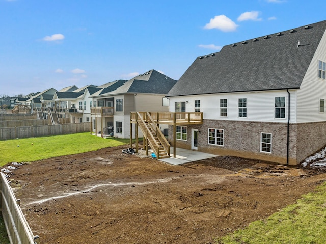 rear view of property with a lawn, a residential view, stairway, a wooden deck, and a patio area